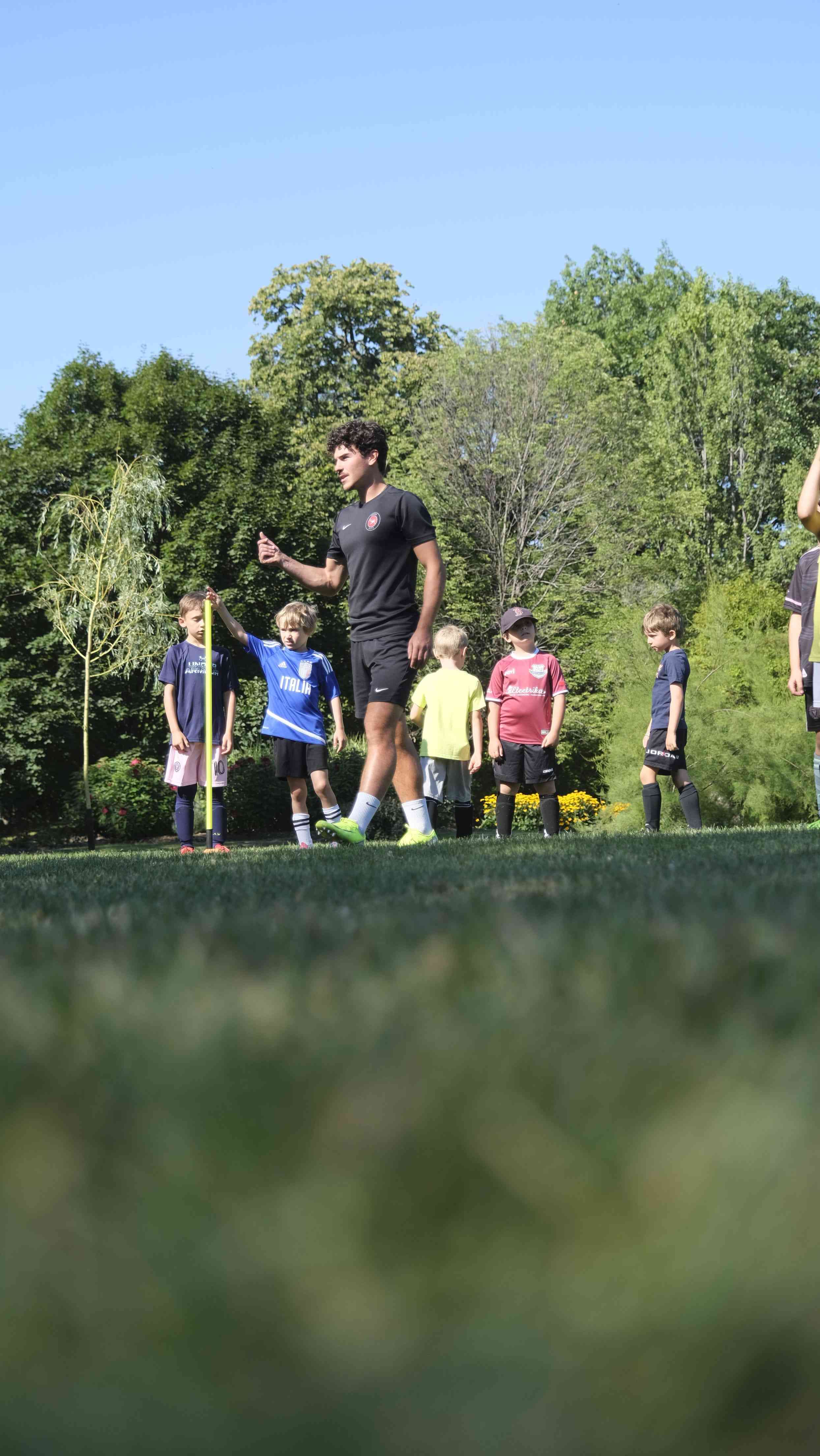 Children aged 6-8 learning soccer skills and making friends